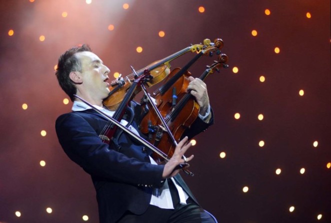 Ukrainian virtuoso violinist Oleksandr Bozhyk plays four violins at the same time as he performs ''Requiem for a Dream" by Clint Mansell during his solo concert in the western Ukrainian city of Lviv on December 8, 2012. TOPSHOTS/AFP PHOTO/YURIY DYACHYSHYNYURIY DYACHYSHYN/AFP/Getty Images ORG XMIT: 168