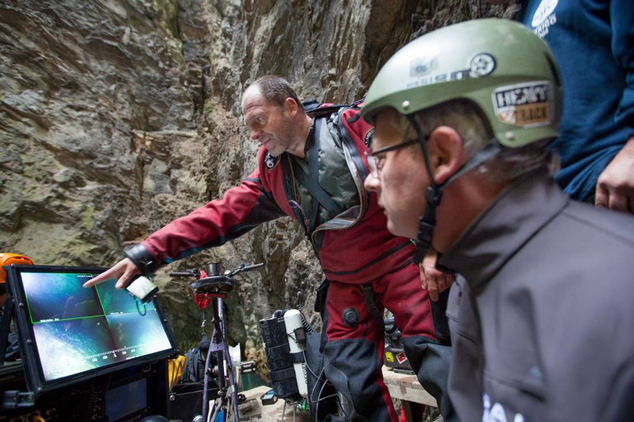 In this photo taken Sept. 27, 2016 in the flooded Hranicka Propast, or Hranice Abyss, in the Czech Republic Polish explorer Krzysztof Starnawski, left, and Bartlomiej Grynda, right, are reading images from a remotely-operated underwater robot, or ROV, that went to the record depth of 404 meters ,1,325 feet, revealing the limestone abyss to be the world's deepest flooded cave, during the 'Hranicka Propast - step beyond 400m' expedition led by Starnawski and partly funded by the National Geographic. (AP Photo/ Marcin Jamkowski)