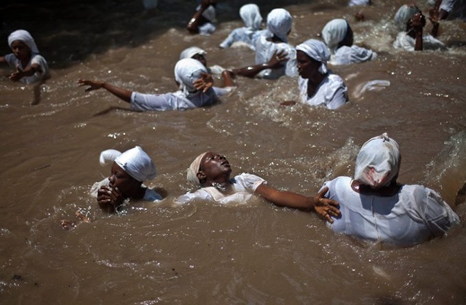 Believers swim in a sacred pool in Souvenance, Haiti