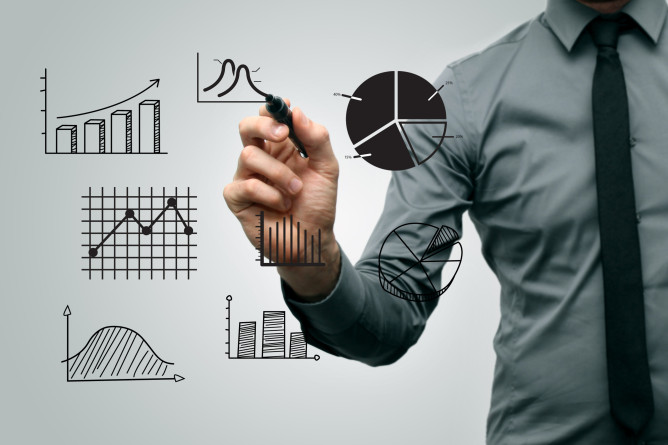 business man drawing different graphs and charts