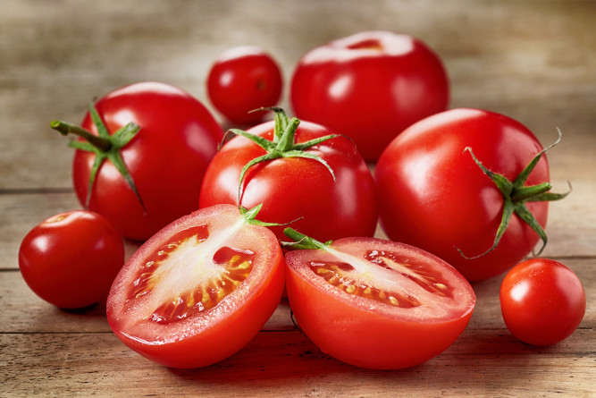 Fresh red tomatoes on wooden table