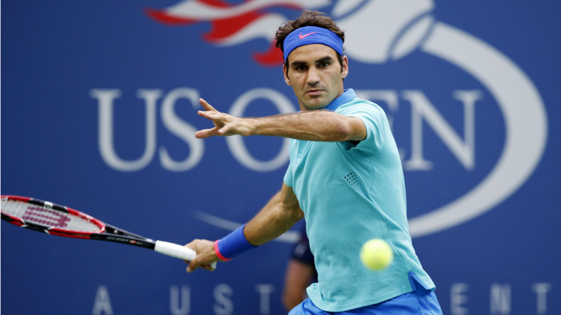 Roger Federer, of Switzerland, returns a shot against Marcel Granollers, of Spain, during the third round of the 2014 U.S. Open tennis tournament, Sunday, Aug. 31, 2014, in New York. (AP Photo/Kathy Willens)